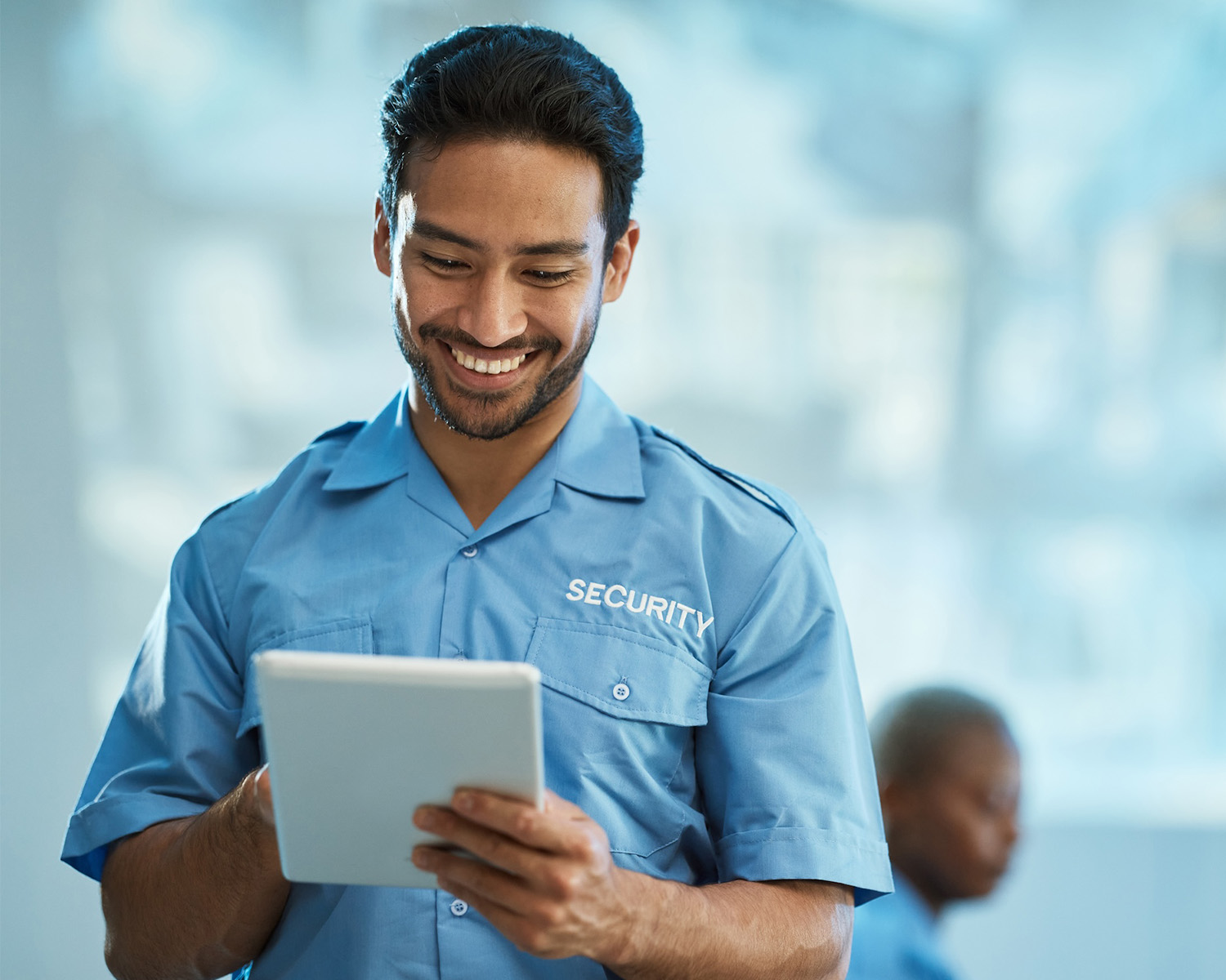 Happy asian man, security guard and tablet for surveillance, research or browsing at the office. Male person, police or officer smile on technology for social media, networking or communication.